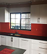 Custom red glass splashback kitchen renovation